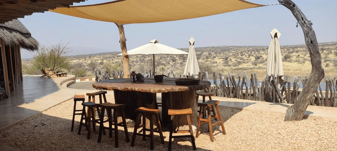 Safari lodge dining area with panoramic Namibian landscape views